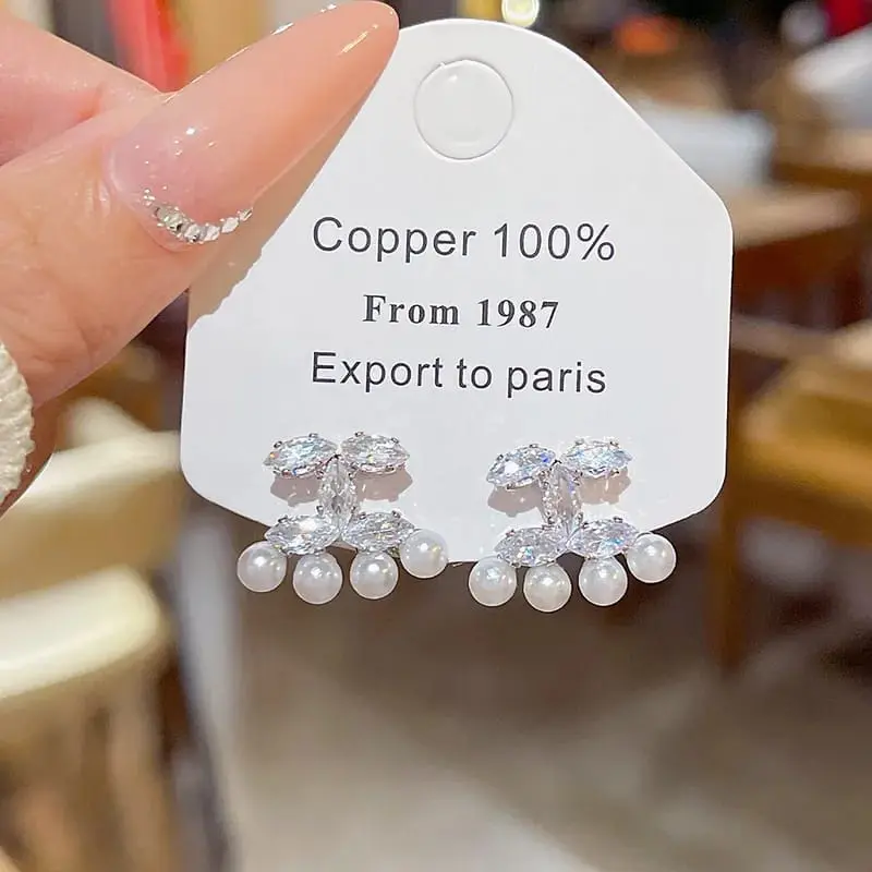 Aretes moño plateado con perlas fantasía 2642417